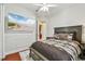 Bedroom with large beach-themed TV and ceiling fan at 15005 Lake Emerald Blvd, Tampa, FL 33618