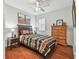 Bedroom with wooden dresser and wood flooring at 15005 Lake Emerald Blvd, Tampa, FL 33618