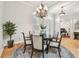 Bright dining room with hardwood floors, chandelier, and access to the office at 15005 Lake Emerald Blvd, Tampa, FL 33618