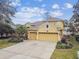 Two-story house with a two-car garage and landscaped yard at 15005 Lake Emerald Blvd, Tampa, FL 33618