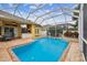 Screened pool with outdoor kitchen and dining at 15005 Lake Emerald Blvd, Tampa, FL 33618