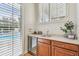 Convenient wet bar with a mini-fridge and sink, perfect for entertaining at 15005 Lake Emerald Blvd, Tampa, FL 33618
