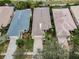 Aerial view of three homes with unique roof styles at 1531 Riverdale Dr, Oldsmar, FL 34677