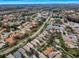 Aerial view showcasing a neighborhood's layout, including a pond and various houses at 1531 Riverdale Dr, Oldsmar, FL 34677