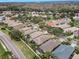 Aerial view of a community with houses, roads, and lush greenery at 1531 Riverdale Dr, Oldsmar, FL 34677