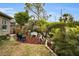 Landscaped backyard with a garden and a white bench at 1531 Riverdale Dr, Oldsmar, FL 34677