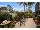 Landscaped backyard with seating area and tranquil fountain at 1531 Riverdale Dr, Oldsmar, FL 34677