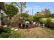 Landscaped backyard with multiple seating areas, lush greenery, and a screened patio at 1531 Riverdale Dr, Oldsmar, FL 34677