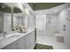 Spa-like bathroom with double vanity and a glass-block window at 1531 Riverdale Dr, Oldsmar, FL 34677