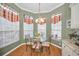 Bright breakfast nook features a glass-top table and chairs, and three windows at 1531 Riverdale Dr, Oldsmar, FL 34677