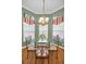 Charming breakfast nook with glass table, four chairs, and a chandelier at 1531 Riverdale Dr, Oldsmar, FL 34677