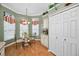 Bright breakfast nook with a glass-top table and chairs, built in cabinetry and window seating at 1531 Riverdale Dr, Oldsmar, FL 34677