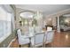 Bright dining room with hardwood floors, chandelier, and kitchen views at 1531 Riverdale Dr, Oldsmar, FL 34677