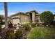 One-story house with a two-car garage, mature landscaping, and a light taupe exterior at 1531 Riverdale Dr, Oldsmar, FL 34677