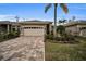One-story house with a two-car garage and a brick paved driveway at 1531 Riverdale Dr, Oldsmar, FL 34677