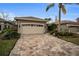 One-story house with a two-car garage and a brick paved driveway at 1531 Riverdale Dr, Oldsmar, FL 34677