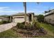 Tan one-story house with a two-car garage and landscaped front yard at 1531 Riverdale Dr, Oldsmar, FL 34677