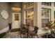 Cozy front porch with seating for two and view into the kitchen at 1531 Riverdale Dr, Oldsmar, FL 34677