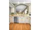 Kitchen with granite countertops, stainless steel dishwasher and hardwood floors at 1531 Riverdale Dr, Oldsmar, FL 34677