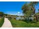 Peaceful lakefront view with walking path and bench at 1531 Riverdale Dr, Oldsmar, FL 34677