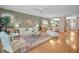 Open living space with hardwood floors, comfortable seating, and views to the kitchen and entry at 1531 Riverdale Dr, Oldsmar, FL 34677