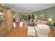 Living room with hardwood floors, comfortable seating, and large windows at 1531 Riverdale Dr, Oldsmar, FL 34677