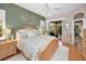 Main bedroom with king-size bed and access to the backyard at 1531 Riverdale Dr, Oldsmar, FL 34677