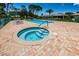 Community pool and spa with lounge chairs for relaxing at 1531 Riverdale Dr, Oldsmar, FL 34677