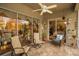 Cozy screened patio features seating for two and garden access at 1531 Riverdale Dr, Oldsmar, FL 34677