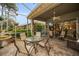 This screened patio has a table and chairs for outdoor dining at 1531 Riverdale Dr, Oldsmar, FL 34677