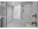 Walk-in shower with marble tile and glass enclosure at 1531 Riverdale Dr, Oldsmar, FL 34677