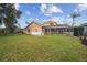 Expansive backyard with screened pool and patio at 1551 Daylily Dr, Trinity, FL 34655