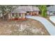 Aerial view of a charming house with a landscaped yard and driveway at 1612 Fox Run Dr, Tarpon Springs, FL 34689