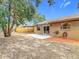 Backyard with patio, fenced yard, and trees at 1612 Fox Run Dr, Tarpon Springs, FL 34689