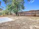Fenced backyard with patio and mature trees at 1612 Fox Run Dr, Tarpon Springs, FL 34689