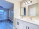 Updated bathroom with double vanity and access to bedroom at 1612 Fox Run Dr, Tarpon Springs, FL 34689