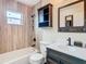 Updated bathroom with wood-look tile and vanity at 1612 Fox Run Dr, Tarpon Springs, FL 34689