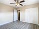 Bright bedroom featuring wood-look floors and ceiling fan at 1612 Fox Run Dr, Tarpon Springs, FL 34689