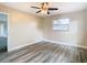 Bright bedroom with wood-look floors and a ceiling fan at 1612 Fox Run Dr, Tarpon Springs, FL 34689