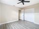Bedroom with wood-look floors, ceiling fan, and closet at 1612 Fox Run Dr, Tarpon Springs, FL 34689