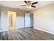 Spacious bedroom with wood-look floors, ceiling fan and bathroom access at 1612 Fox Run Dr, Tarpon Springs, FL 34689