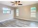 Well-lit bedroom with wood-look floors and ceiling fan at 1612 Fox Run Dr, Tarpon Springs, FL 34689