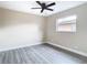 Bedroom with wood-look floors, window, and ceiling fan at 1612 Fox Run Dr, Tarpon Springs, FL 34689