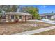 Cute ranch home with landscaped yard and a paved driveway at 1612 Fox Run Dr, Tarpon Springs, FL 34689