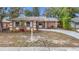 Updated single-story home with landscaped yard and new driveway at 1612 Fox Run Dr, Tarpon Springs, FL 34689