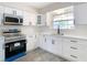 Modern white kitchen with stainless steel appliances at 1612 Fox Run Dr, Tarpon Springs, FL 34689