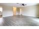 Bright living room featuring wood-look floors and a ceiling fan at 1612 Fox Run Dr, Tarpon Springs, FL 34689