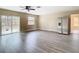 Spacious living room with grey vinyl plank floors and sliding doors at 1612 Fox Run Dr, Tarpon Springs, FL 34689