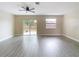 Living room featuring vinyl plank flooring and sliding glass doors at 1612 Fox Run Dr, Tarpon Springs, FL 34689