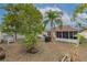 Landscaped backyard with patio and screened enclosure at 1706 Kirtley Dr, Brandon, FL 33511